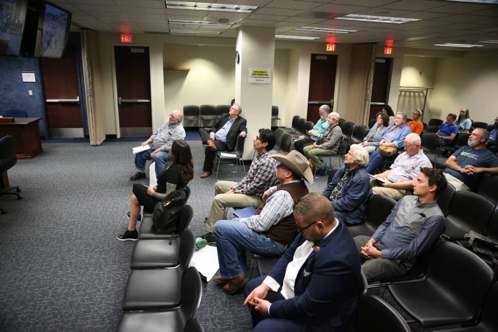 People watch a televised Senate Committee on Natural Resources meeting on a joint resolution opposing plans to expand an Air Force bombing range in Southern Nevada, at the Grant Sawyer State Offic ...