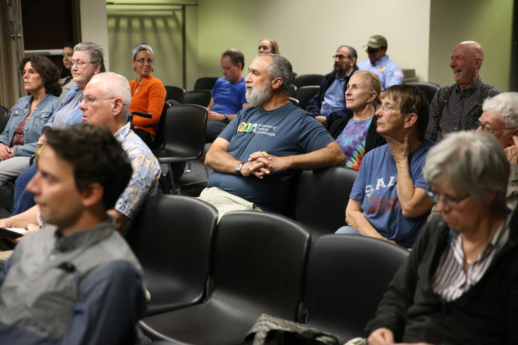 People watch a televised Senate Committee on Natural Resources meeting on a joint resolution opposing plans to expand an Air Force bombing range in Southern Nevada, at the Grant Sawyer State Offic ...