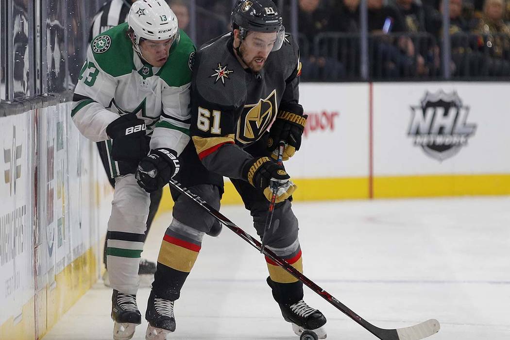 Dallas Stars center Mattias Janmark (13) vies for the puck with Vegas Golden Knights right wing Mark Stone (61) during the first period of an NHL hockey game Tuesday, Feb. 26, 2019, in Las Vegas. ...