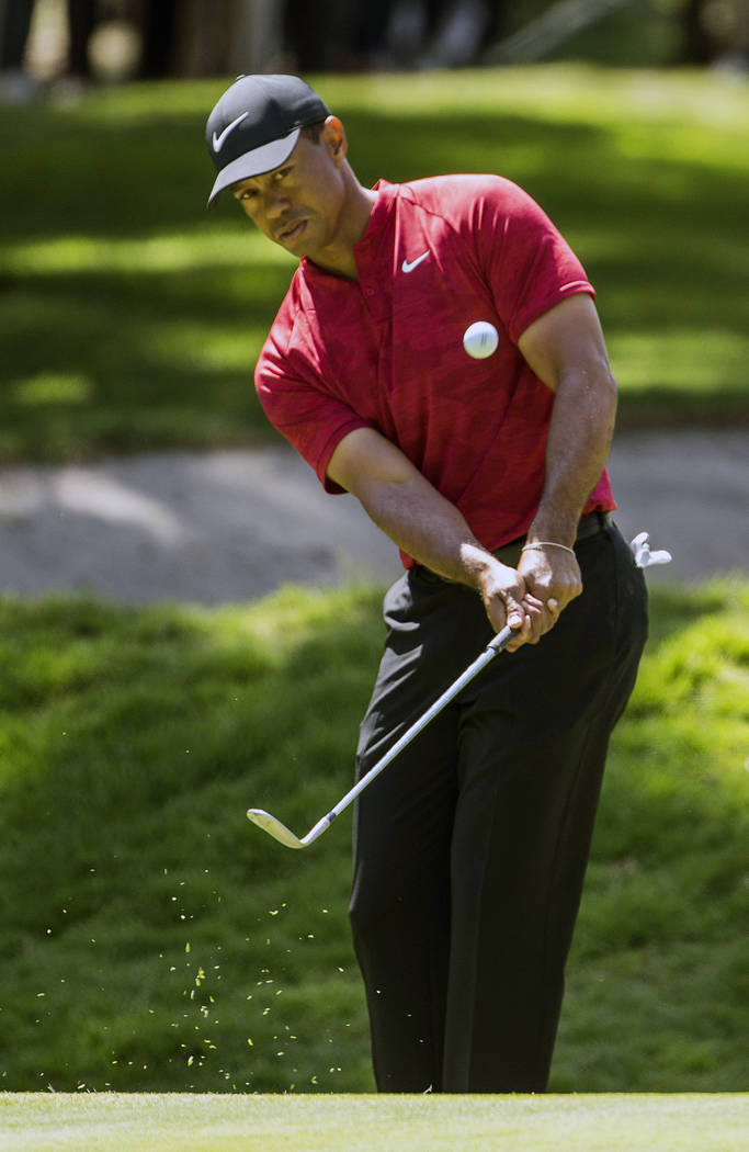 FILE - In this Feb. 24, 2019, file photo, Tiger Woods hits the ball on the first hole during the WGC-Mexico Championship at the Chapultepec Golf Club in Mexico City. Woods has withdrawn from the A ...