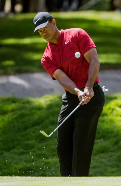 FILE - In this Feb. 24, 2019, file photo, Tiger Woods hits the ball on the first hole during the WGC-Mexico Championship at the Chapultepec Golf Club in Mexico City. Woods has withdrawn from the A ...