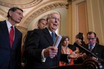 Senate Majority Leader Mitch McConnell, R-Ky., joined from left by Sen. John Barrasso, R-Wyo., Majority Whip John Thune, R-S.D., and Sen. Joni Ernst, R-Iowa, speaks with reporters during a news co ...