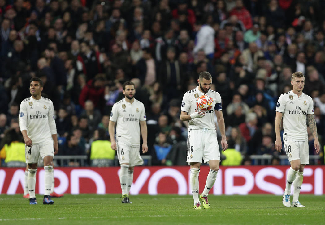 Real forward Karim Benzema holds the ball after being scored by Ajax, during the Champions League soccer match between Real Madrid and Ajax at the Santiago Bernabeu stadium in Madrid, Spain, Tuesd ...
