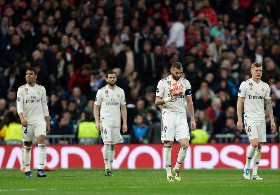 Real forward Karim Benzema holds the ball after being scored by Ajax, during the Champions League soccer match between Real Madrid and Ajax at the Santiago Bernabeu stadium in Madrid, Spain, Tuesd ...