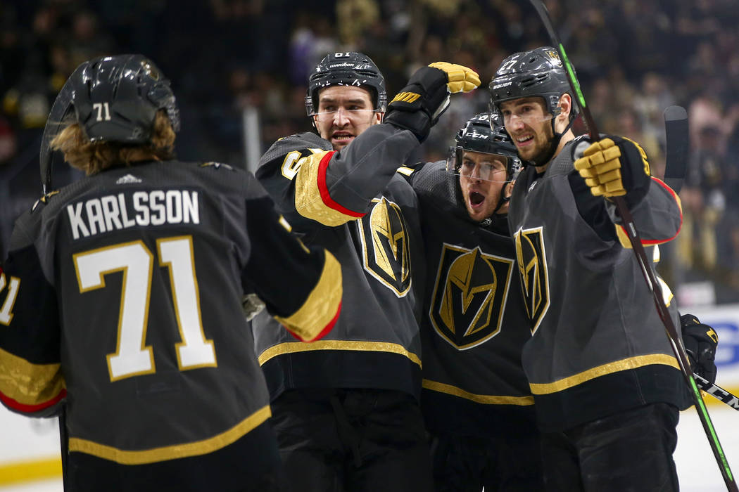Golden Knights defenseman Shea Theodore, right, celebrates his goal with teammates, from left, center William Karlsson, right wing Mark Stone and center Jonathan Marchessault during the first peri ...