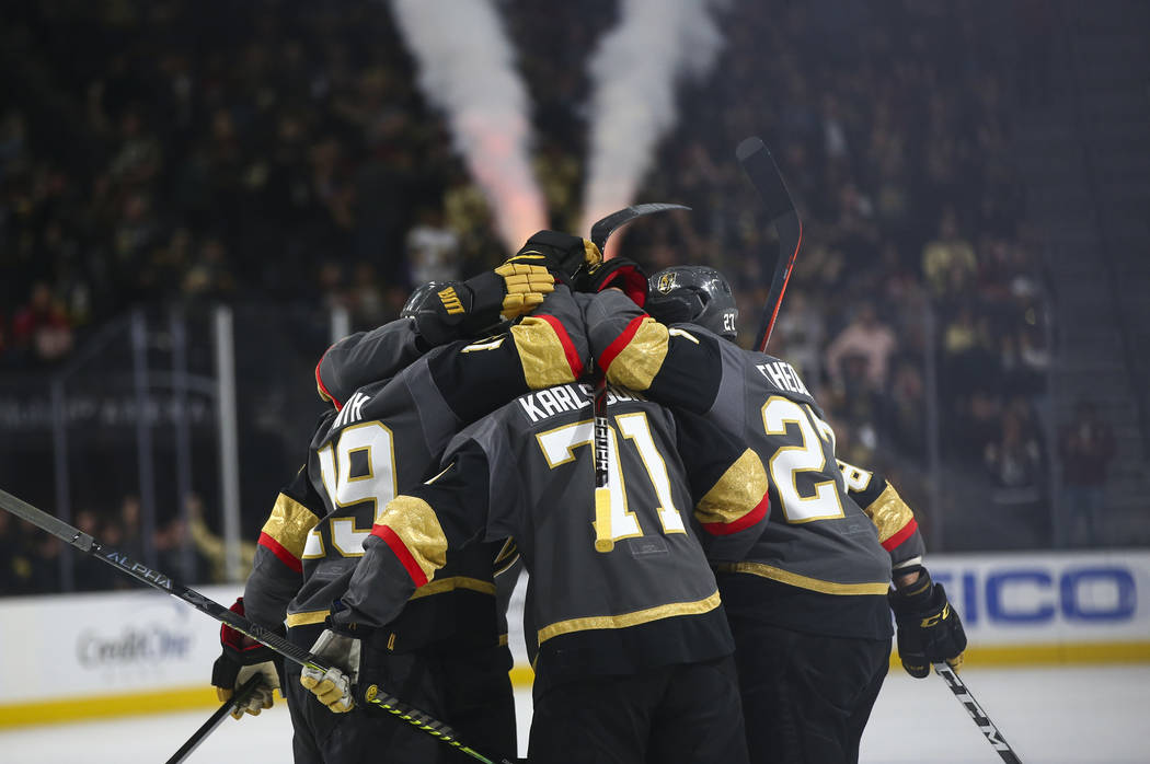 Golden Knights players celebrate a goal against the Calgary Flames during the first period of an NHL hockey game at T-Mobile Arena in Las Vegas on Wednesday, March 6, 2019. (Chase Stevens/Las Vega ...