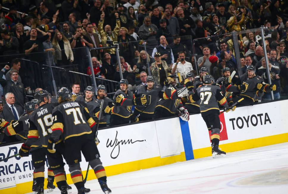 Golden Knights defenseman Shea Theodore (27) celebrates his goal with the bench during the first period of an NHL hockey game against the Calgary Flames at T-Mobile Arena in Las Vegas on Wednesday ...
