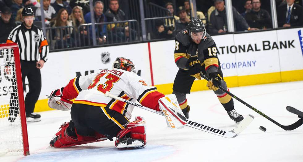 Calgary Flames goaltender David Rittich (33) blocks the puck in front of Golden Knights right wing Reilly Smith (19) during the first period of an NHL hockey game at T-Mobile Arena in Las Vegas on ...