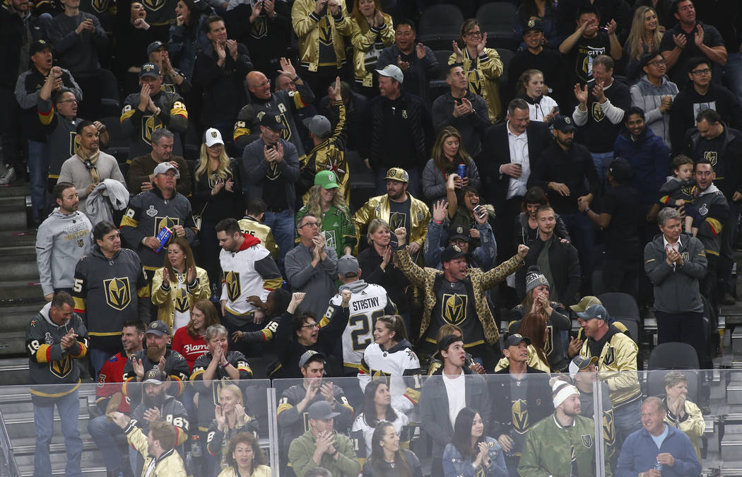 Golden Knights fans celebrate a goal by Golden Knights defenseman Deryk Engelland, not pictured, during the third period of an NHL hockey game against the Calgary Flames at T-Mobile Arena in Las V ...