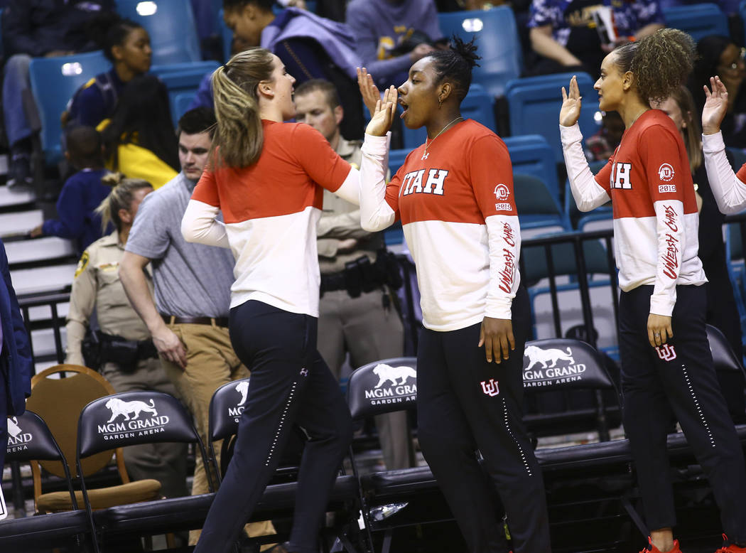 Former Liberty basketball player Dre'Una Edwards, who now plays for Utah, center, cheers on her teammates before the start of a game against Washington during the Pac-12 women's basketball tournam ...