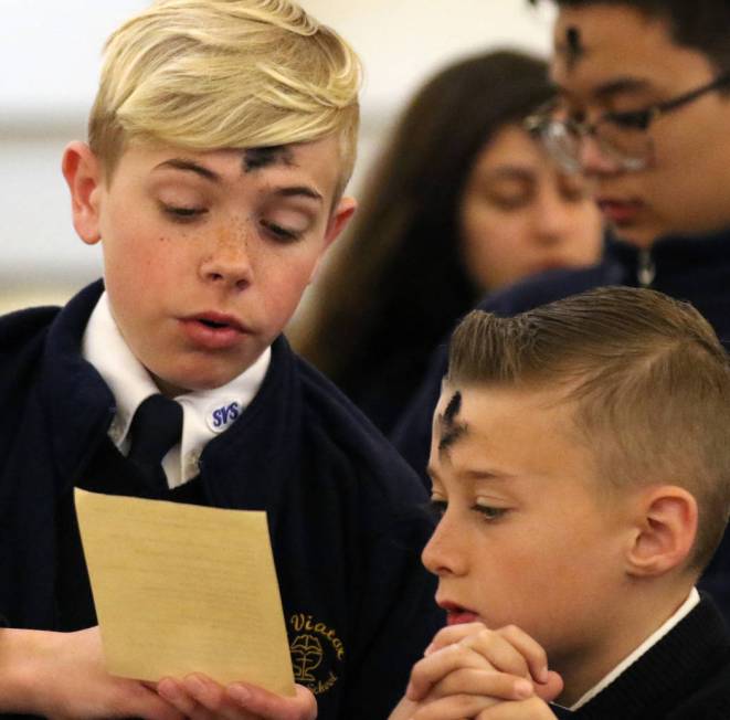 St. Viator Parish School students Stryder Ratajczyk, left, and Levi Garvey, right, celebrate Ash Wednesday at St. Viator Catholic Church on Wednesday, March. 6, 2019, in Las Vegas. Bizuayehu Tesfa ...