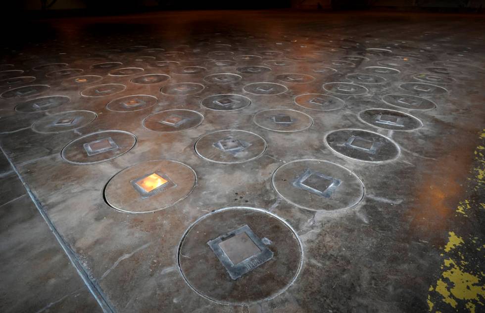 Radioactive waste sealed in large stainless steel canisters is stored under five feet of concrete in a storage building at the Savannah River Site near Aiken, S.C., Nov. 20, 2013. (Stephen B. Mort ...