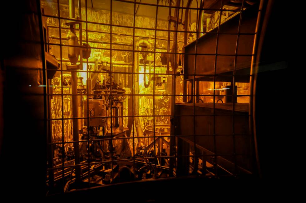 Seen through thick protective glass, shows the area where workers sand-blast the large stainless steel tanks used in the vitrification process to rid them of contaminates at the Defense Waste Proc ...