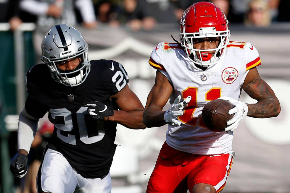 Kansas City Chiefs wide receiver Demarcus Robinson (11) runs in front of Oakland Raiders cornerback Daryl Worley (20) during the first half of an NFL football game in Oakland, Calif., Sunday, Dec. ...