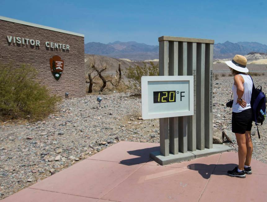 A visitor looks at the temperature displayed at visitor center at Death Valley National Park, Calif., on Tuesday, Aug. 7, 2018. (Chase Stevens Las Vegas Review-Journal @csstevensphoto)