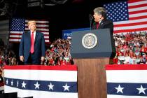 President Donald Trump listens Fox News' Sean Hannity speak during a rally at Show Me Center, Monday, Nov. 5, 2018, in Cape Girardeau, Mo.. (AP Photo/Carolyn Kaster)