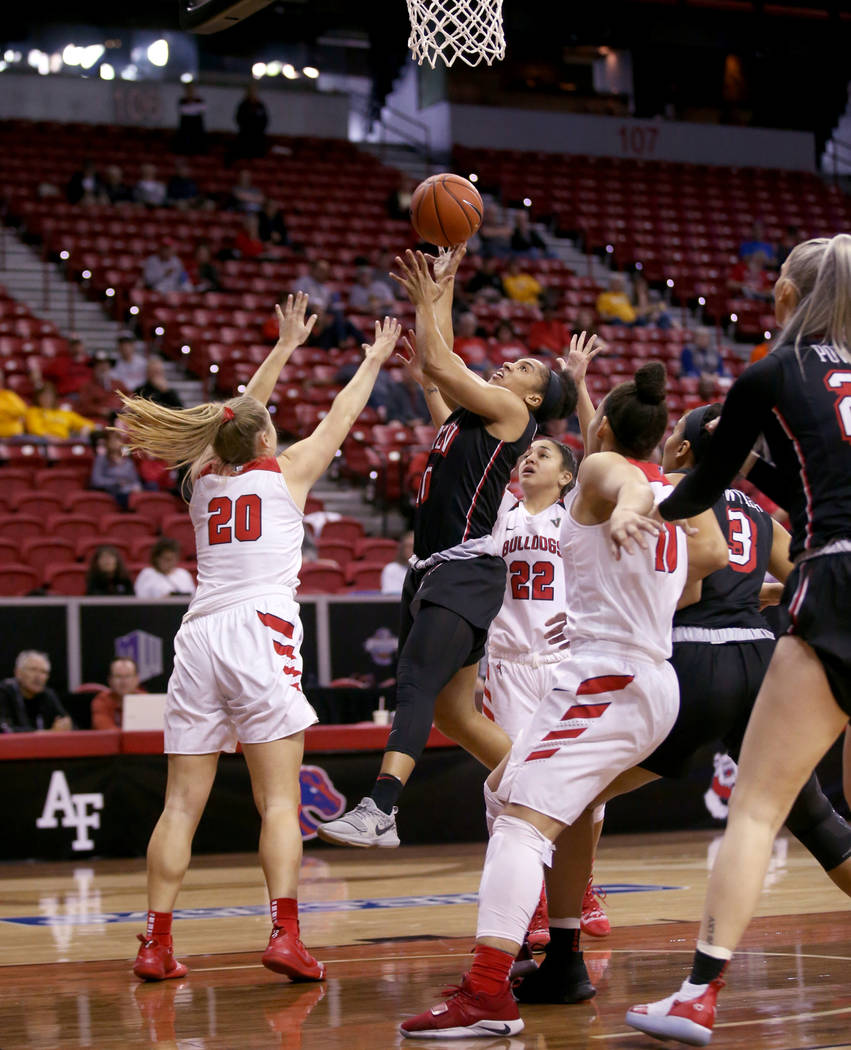 UNLV Lady Rebels guard Nikki Wheatley (10) shoots over Fresno State Bulldogs guard Bree Delaney (20) in the first quarter of their quarterfinal game of the Mountain West women's basketball tournam ...