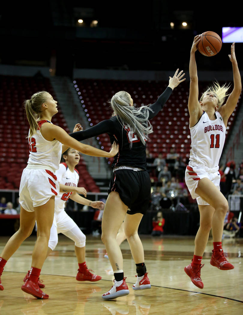Fresno State Bulldogs forward Maddi Utti (11) intercepts a pass for UNLV Lady Rebels forward Katie Powell (21) in the first quarter of their quarterfinal game of the Mountain West women's basketba ...