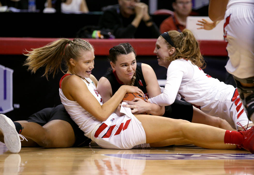 UNLV Lady Rebels forward Alyssa Anderson (20), center, fights for the ball against Fresno State Bulldogs Genna Ogier (12), left, and Kristina Cavey (30) in the second quarter of their quarterfinal ...