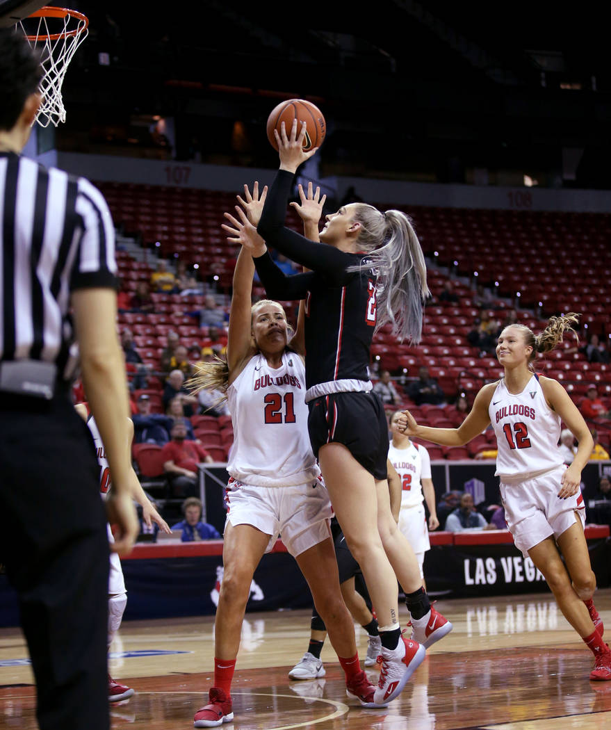 UNLV Lady Rebels forward Katie Powell (21) shoots over Fresno State Bulldogs forward Lydia Friberg (21) in the second quarter of their quarterfinal game in the Mountain West women's basketball tou ...