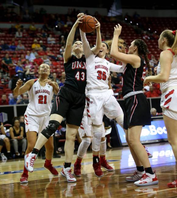 UNLV Lady Rebels center Haley Bodnar Rydalch (43) and Fresno State Bulldogs forward Kristina Cavey (30) battle for a rebound in the third quarter of their quarterfinal game in the Mountain West wo ...