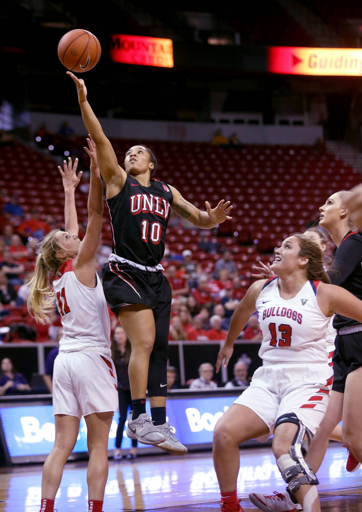 UNLV Lady Rebels guard Nikki Wheatley (10) shoots over Fresno State Bulldogs forward Maddi Utti (11) in the fourth quarter of their quarterfinal game in the Mountain West women's basketball tourna ...