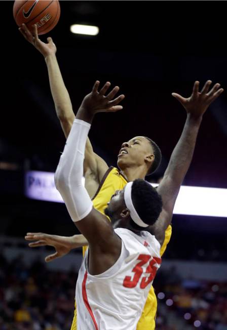 Wyoming's Brandon Porter shoots over New Mexico's Carlton Bragg during the first half of an NCAA college basketball game in the Mountain West Conference tournament Wednesday, March 13, 2019, in La ...