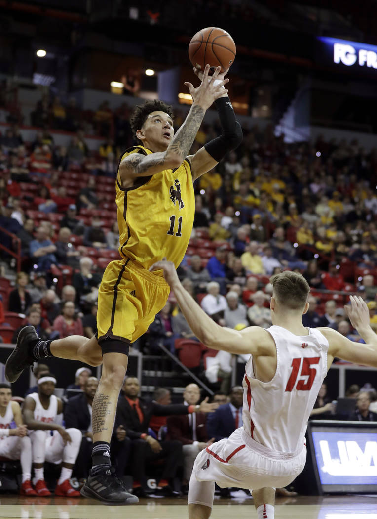 Wyoming's Trace Young shoots over New Mexico's Trey Porter during the first half of an NCAA college basketball game in the Mountain West Conference tournament, Wednesday, March 13, 2019, in Las Ve ...