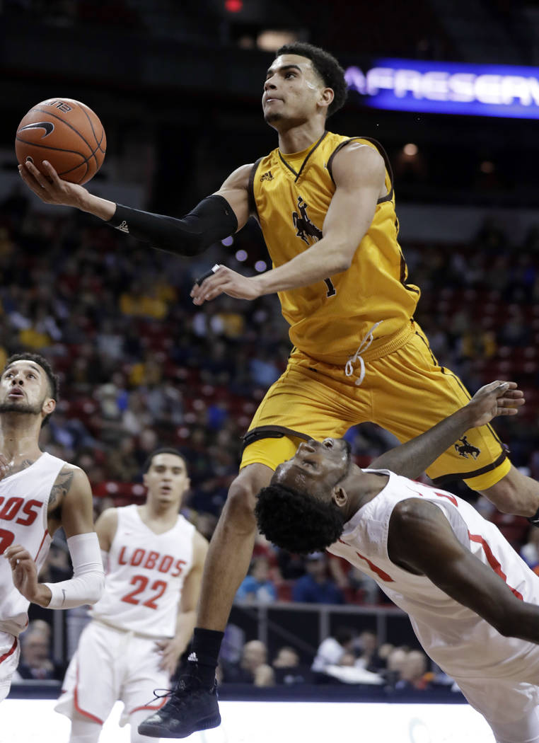 Wyoming's Justin James shoots over New Mexico's Jalen Harris during the first half of an NCAA college basketball game in the Mountain West Conference men's tournament Wednesday, March 13, 2019, in ...