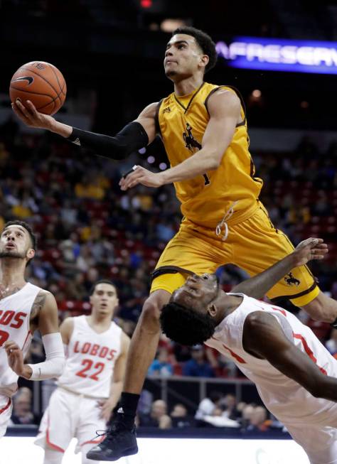 Wyoming's Justin James shoots over New Mexico's Jalen Harris during the first half of an NCAA college basketball game in the Mountain West Conference men's tournament Wednesday, March 13, 2019, in ...