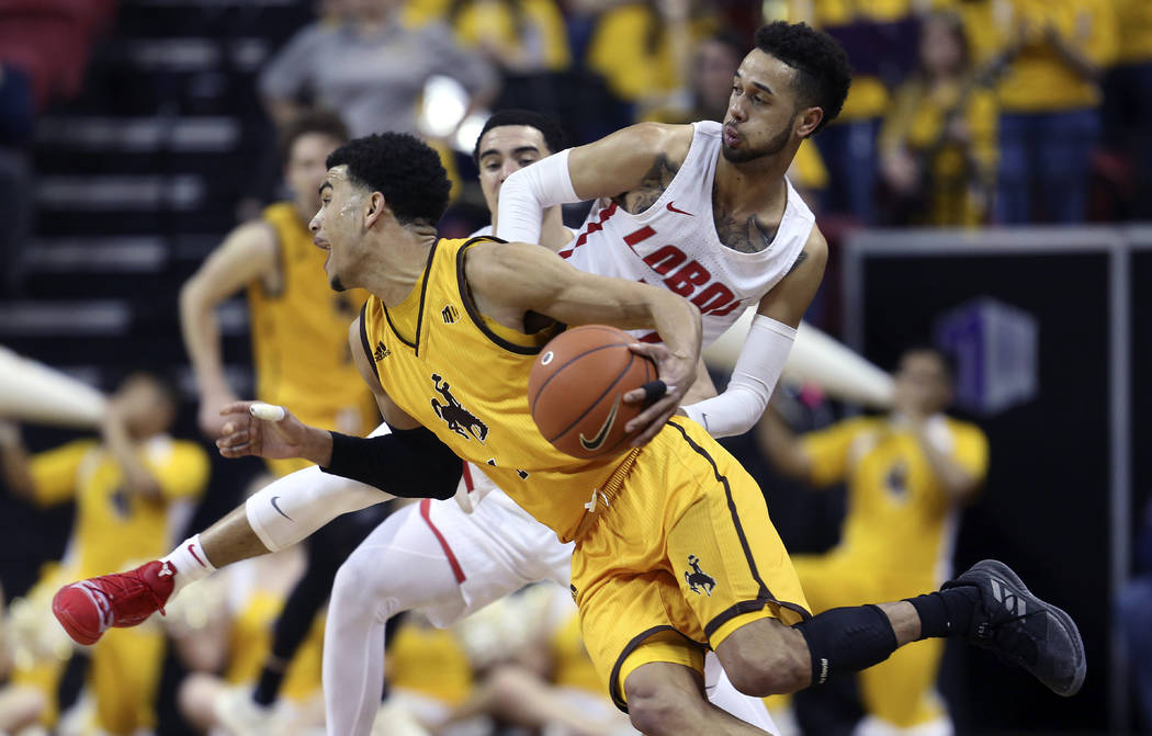 Wyoming's Justin James drives past New Mexico's Anthony Mathis during the second half of an NCAA college basketball game in the Mountain West Conference tournament, Wednesday, March 13, 2019, in L ...