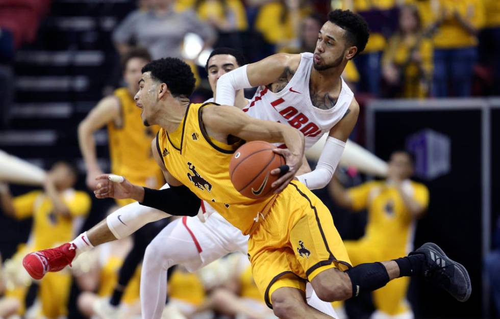 Wyoming's Justin James drives past New Mexico's Anthony Mathis during the second half of an NCAA college basketball game in the Mountain West Conference tournament, Wednesday, March 13, 2019, in L ...