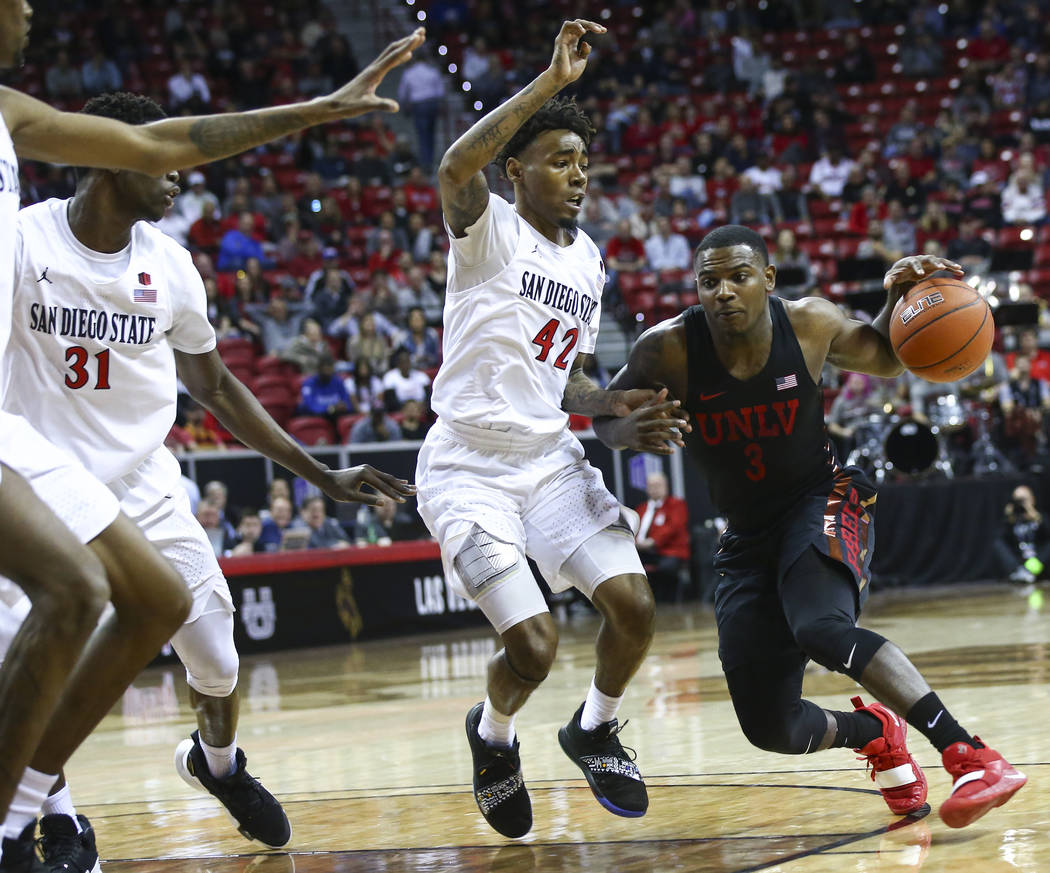 UNLV Rebels guard Amauri Hardy (3) drives against San Diego State Aztecs guard Jeremy Hemsley (42) during the first half of a quarterfinal game in the Mountain West men's basketball tournament at ...