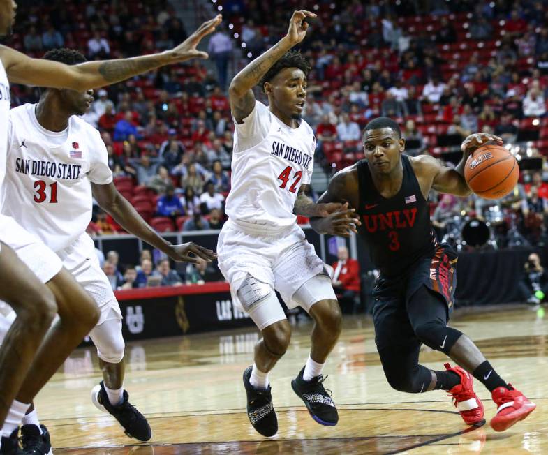 UNLV Rebels guard Amauri Hardy (3) drives against San Diego State Aztecs guard Jeremy Hemsley (42) during the first half of a quarterfinal game in the Mountain West men's basketball tournament at ...