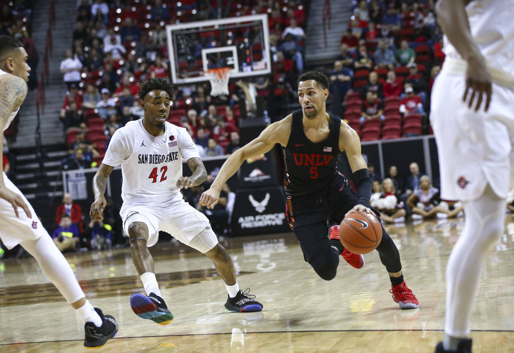 UNLV Rebels guard Noah Robotham (5) drives to the basket against San Diego State Aztecs guard Jeremy Hemsley (42) during the first half of a quarterfinal game in the Mountain West men's basketball ...