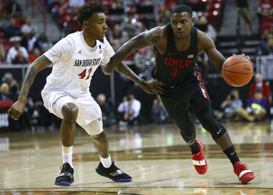 UNLV Rebels guard Amauri Hardy (3) brings the ball up court against San Diego State Aztecs guard Jeremy Hemsley (42) during the first half of a quarterfinal game in the Mountain West men's basketb ...