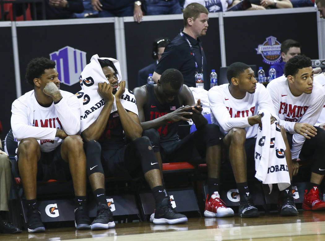 UNLV players on the bench react in the final moments of a quarterfinal game against San Diego State in the Mountain West men's basketball tournament at the Thomas & Mack Center in Las Vegas on ...
