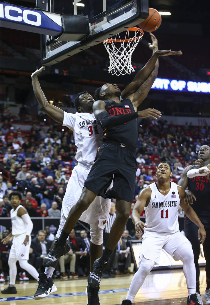 UNLV Rebels guard Kris Clyburn (1) goes to the basket against San Diego State Aztecs forward Nathan Mensah (31) during the second half of a quarterfinal game in the Mountain West men's basketball ...