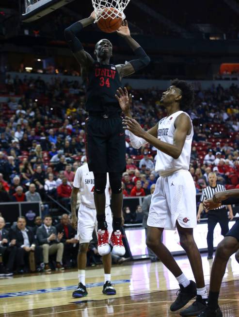UNLV Rebels forward Cheikh Mbacke Diong (34) dunks over San Diego State Aztecs forward Jalen McDaniels during the second half of a quarterfinal game in the Mountain West men's basketball tournamen ...