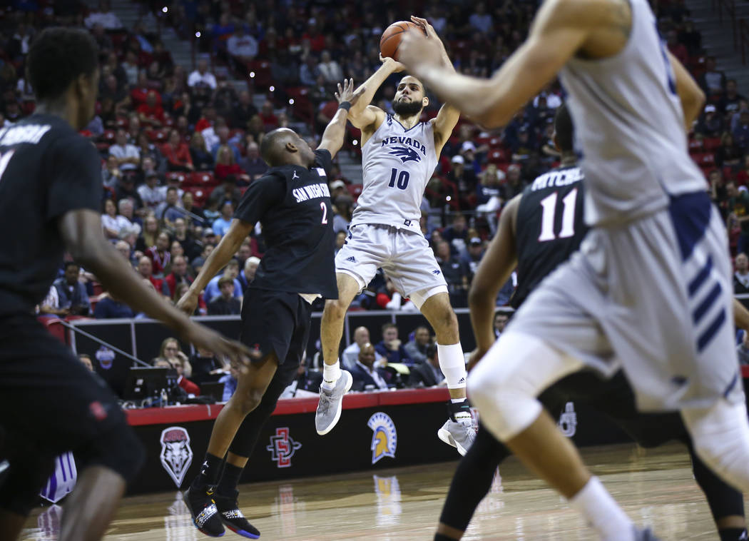 UNR Wolf Pack forward Caleb Martin (10) shoots over San Diego State Aztecs guard Adam Seiko (2) during the second half of a semifinal basketball game in the Mountain West men's basketball tourname ...