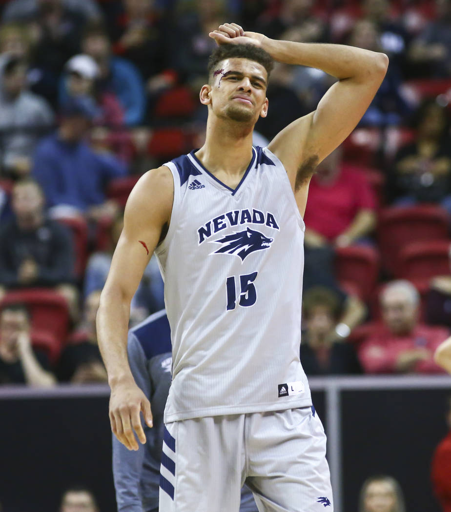 UNR Wolf Pack forward Trey Porter (15) reacts after taking a hard hit and getting called for a flagrant foul during the first half of a semifinal basketball game against San Diego State in the Mou ...