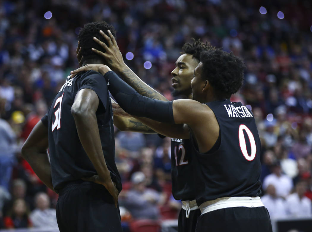 San Diego State Aztecs guards Jeremy Hemsley (42) and Devin Watson (0) console San Diego State Aztecs forward Nathan Mensah (31) after a foul was called on him during the second half of a semifina ...