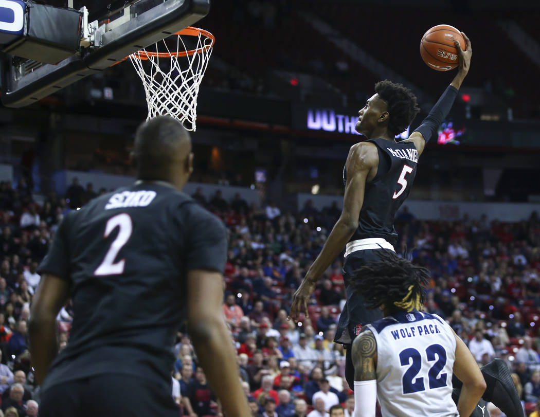 San Diego State Aztecs forward Jalen McDaniels (5) goes to the basket past UNR Wolf Pack guard Jazz Johnson (22) during the first half of a semifinal basketball game in the Mountain West men's bas ...