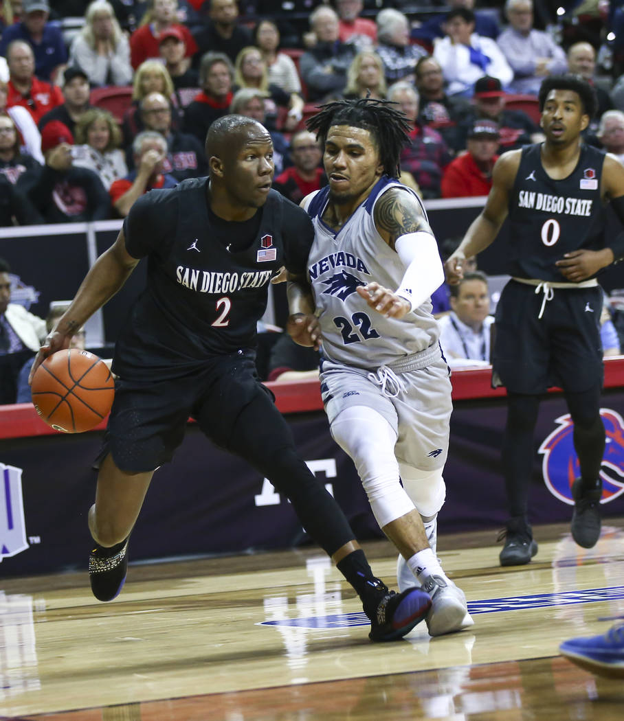 San Diego State Aztecs guard Adam Seiko (2) drives against UNR Wolf Pack guard Jazz Johnson (22) during the first half of a semifinal basketball game in the Mountain West men's basketball tourname ...