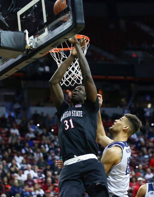 San Diego State Aztecs forward Nathan Mensah (31) goes to the basket against UNR Wolf Pack forward Trey Porter (15) during the first half of a semifinal basketball game in the Mountain West men's ...