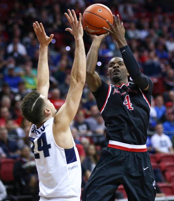 Fresno State Bulldogs guard Braxton Huggins (4) shoots over Utah State Aggies guard Diogo Brito (24) during the first half of a semifinal basketball game in the Mountain West men's basketball tour ...