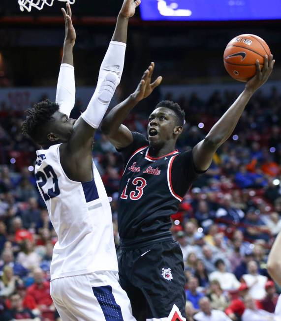 Fresno State Bulldogs guard Aguir Agau (13) goes to the basket againt Utah State Aggies center Neemias Queta (23) during the first half of a semifinal basketball game in the Mountain West men's ba ...