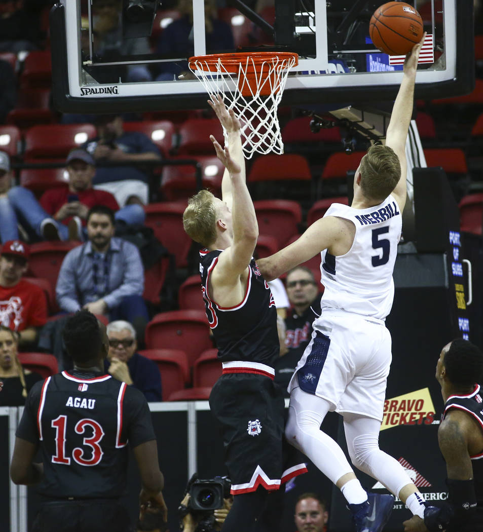 Utah State Aggies guard Sam Merrill (5) goes to the basket against Fresno State Bulldogs forward Sam Bittner during the first half of a semifinal basketball game in the Mountain West men's basketb ...