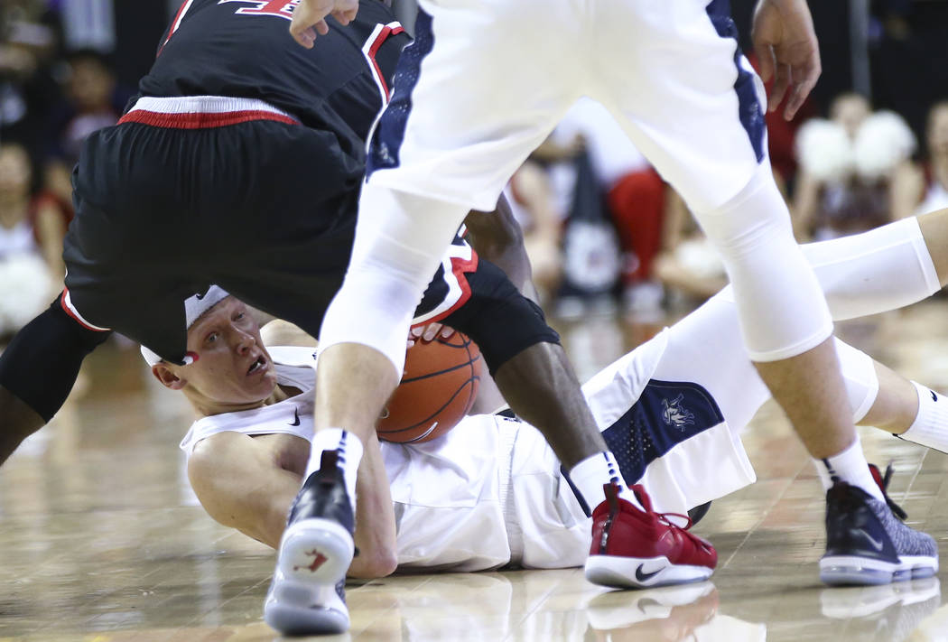 Utah State Aggies guard Brock Miller (22) tries to keep possession of the ball against Fresno State during the first half of a semifinal basketball game in the Mountain West men's basketball tourn ...