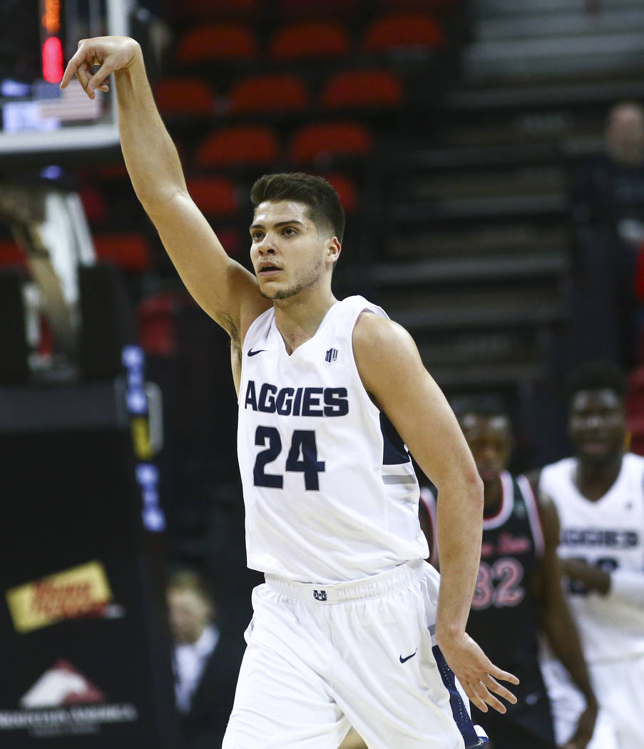 Utah State Aggies guard Diogo Brito celebrates a three-pointer during the first half of a semifinal basketball game against Fresno State in the Mountain West men's basketball tournament at the Tho ...